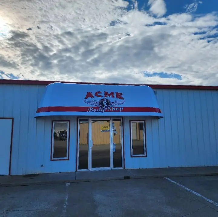 The red Acme Body Shop awning over the storefront entrance on Ong Street
